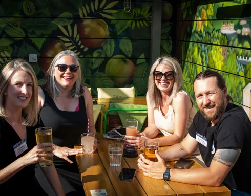 Group of people around a table at the Creative bath reception Group of people around a table at the Creative bath reception