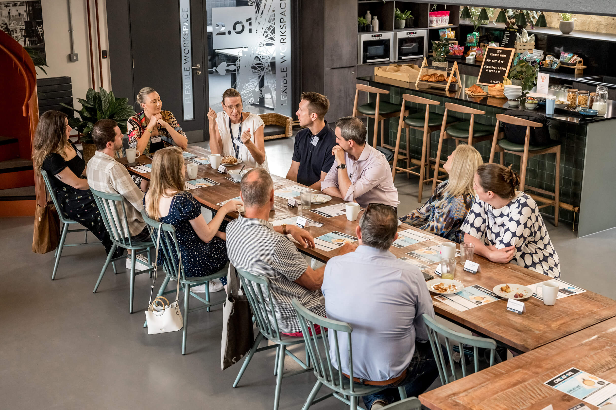 Group at the breakfast club sat around a large table talking