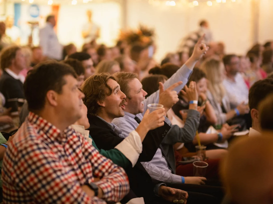 People cheering and raising their drinks